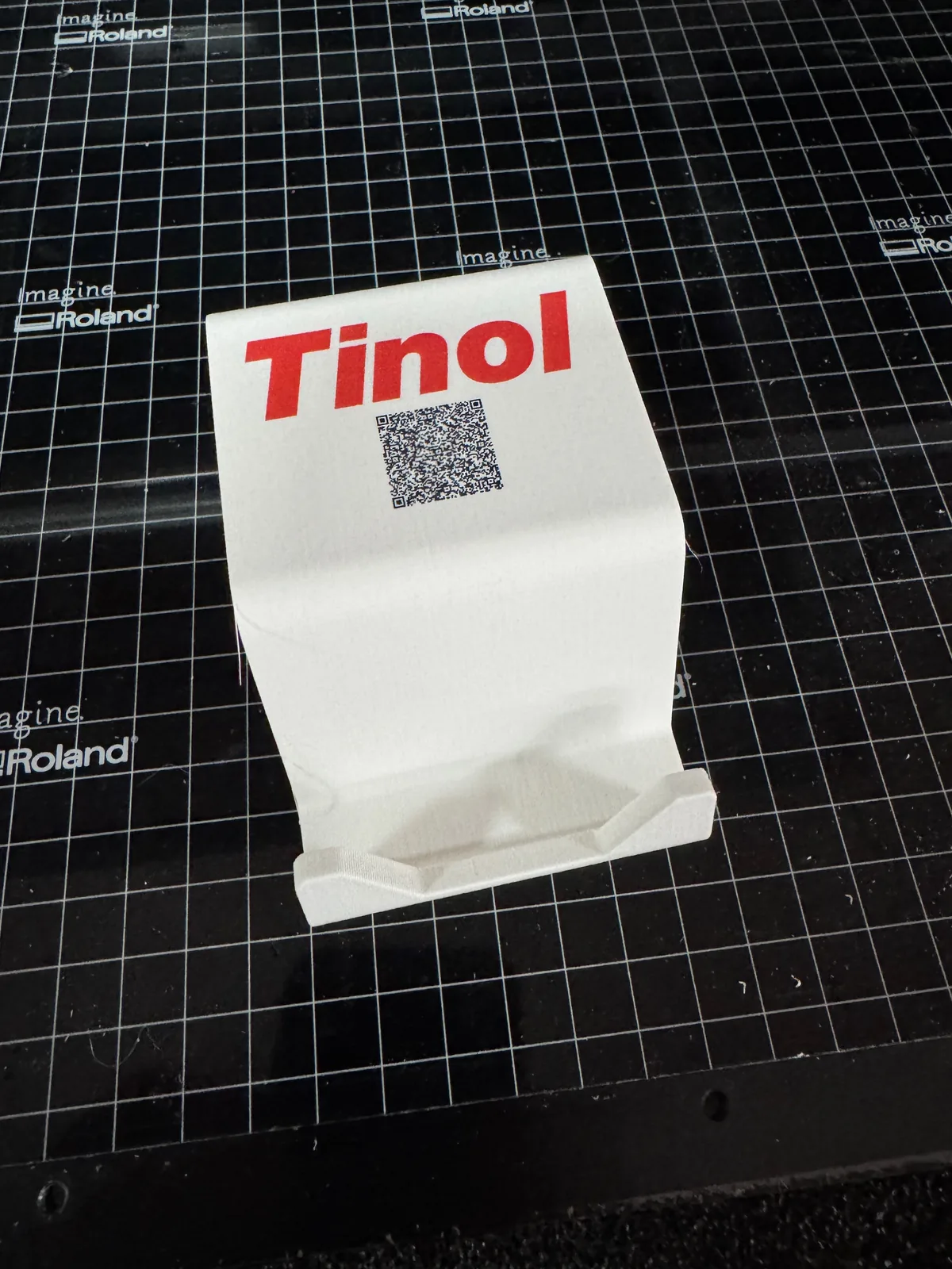 Client-branded phone stand with UV printed logo and QR code on the Roland flatbed