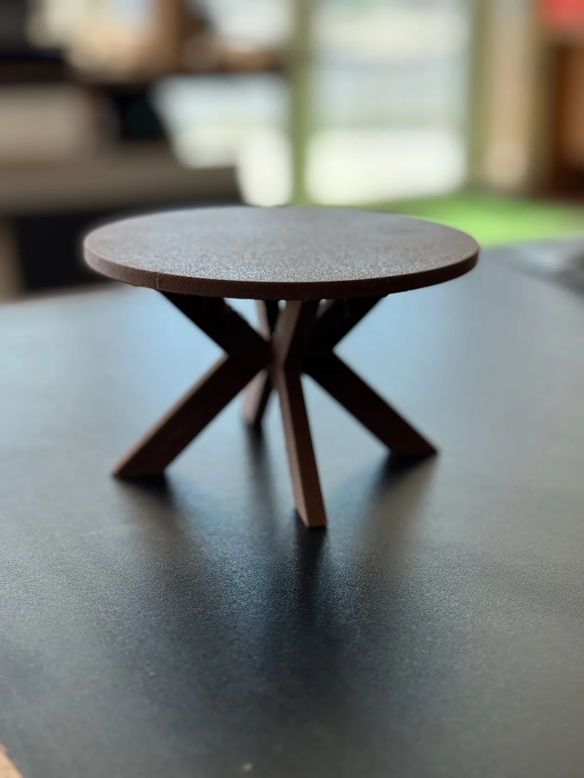 Scale model of an X-leg round dining table 3D printed in wood-fill filament